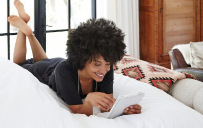 Lady laying down while looking at phone